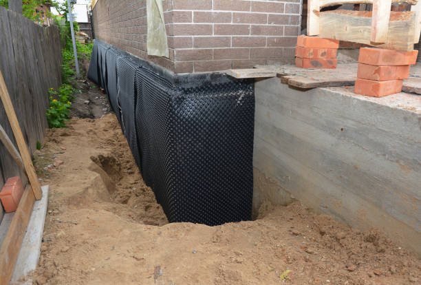 SJ Waterproofing Pros technician performing targeted Interior Drainage System assessment in Lake Mills, WI